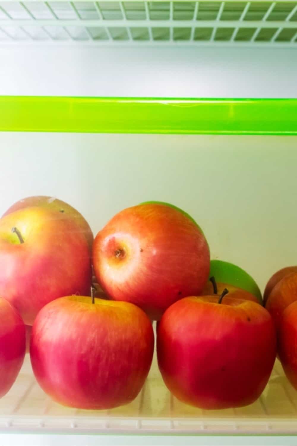 manzanas rojas en el bol de plástico de la nevera