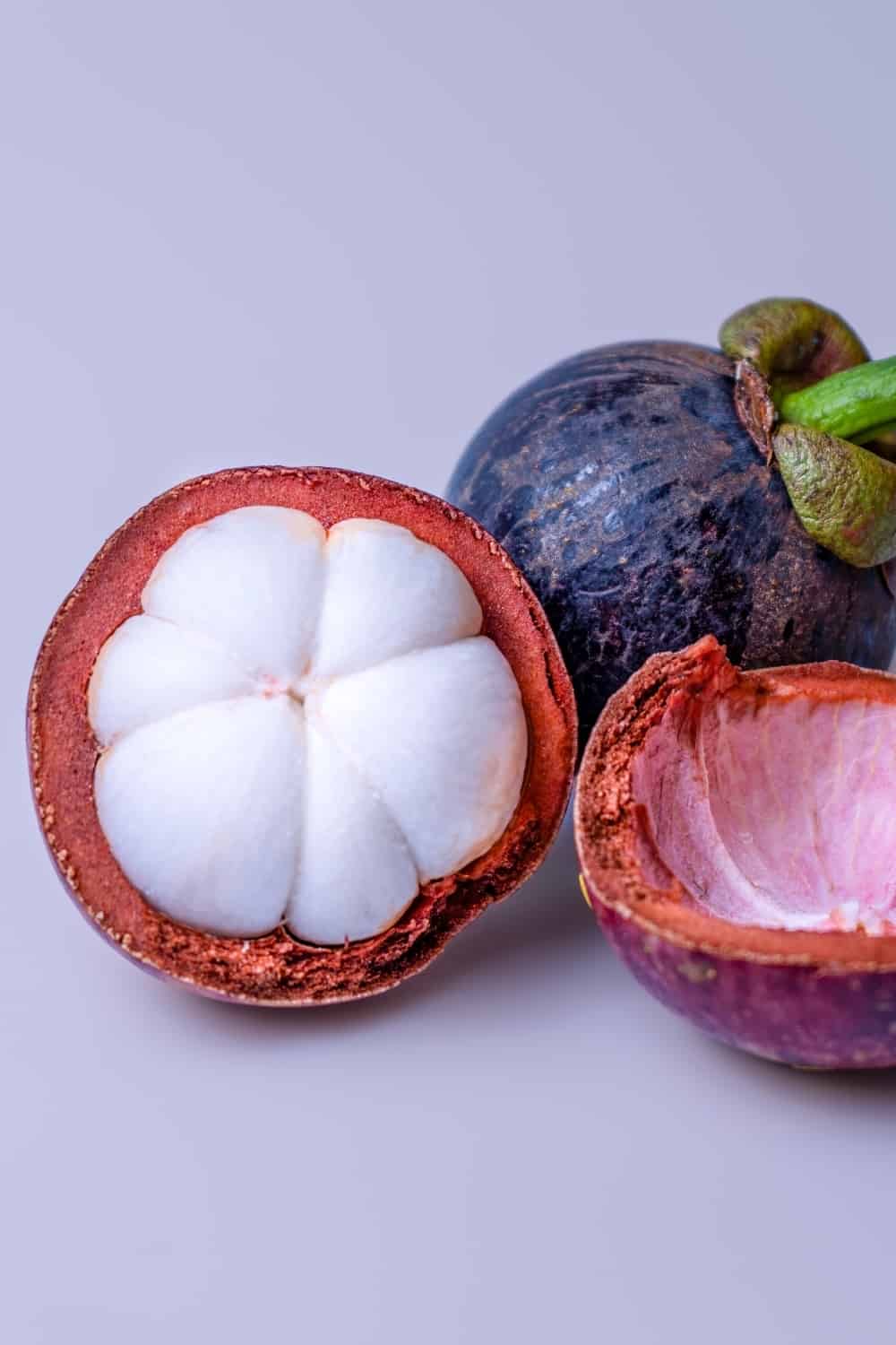 sliced mangosteen on purple background