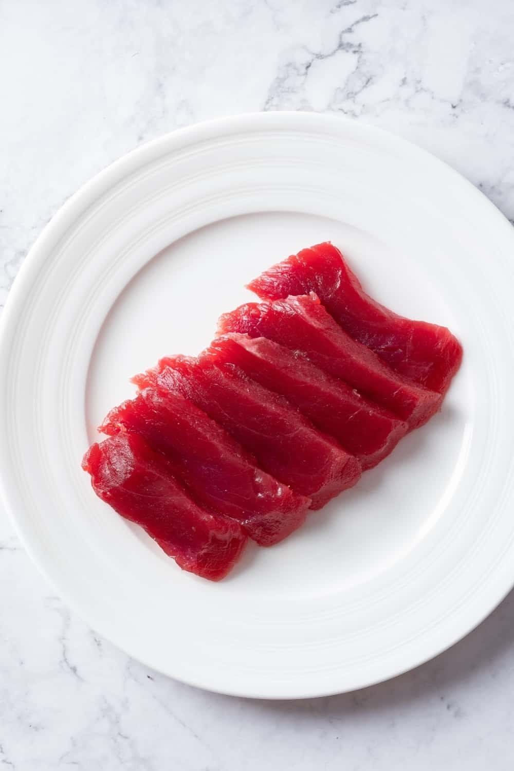Fresh sliced raw tuna on plate