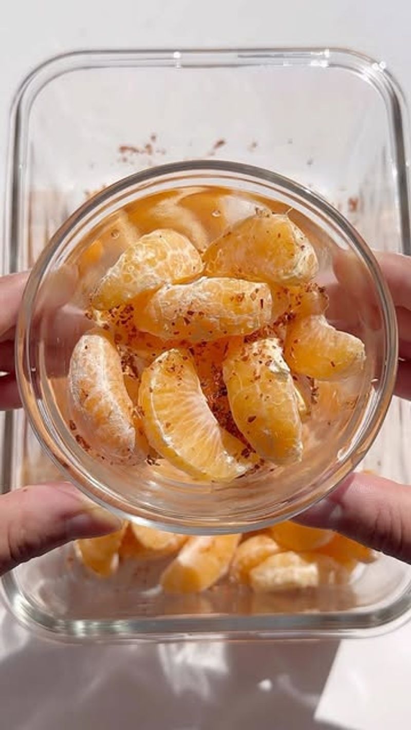 Orange Slices With A Handful Of Almonds