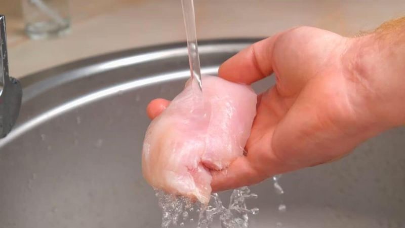 Rinsing Raw Chicken In The Sink